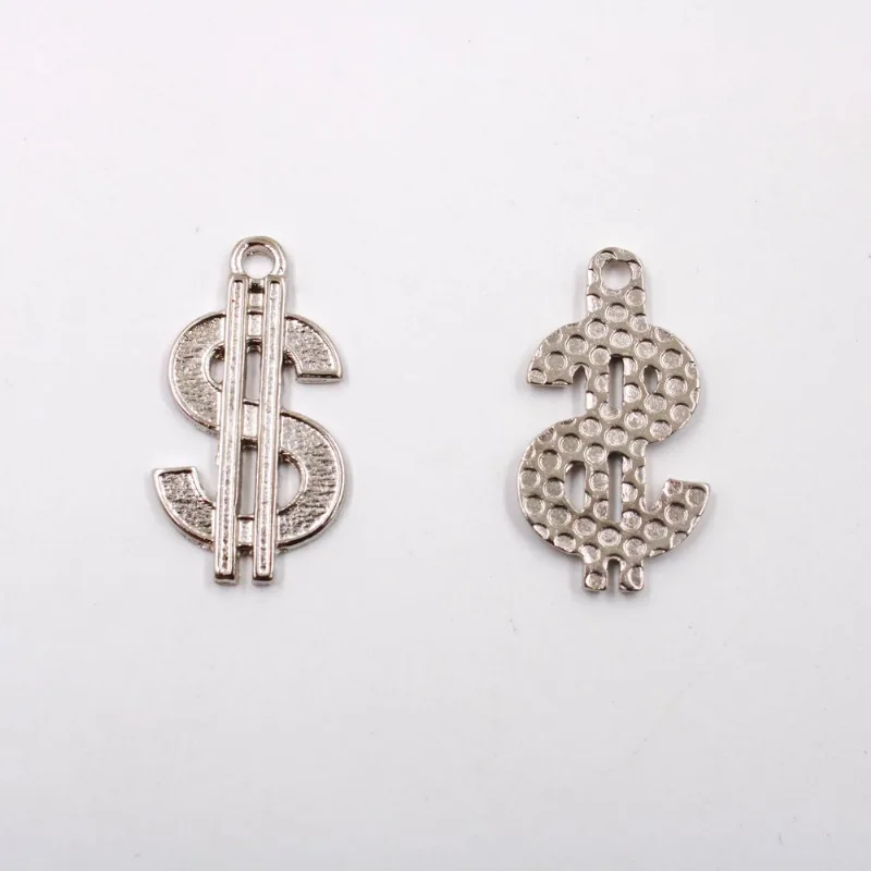 PINGENTE CIFRÃO 30X16MM EM ZAMAC COM 100GR Niquel